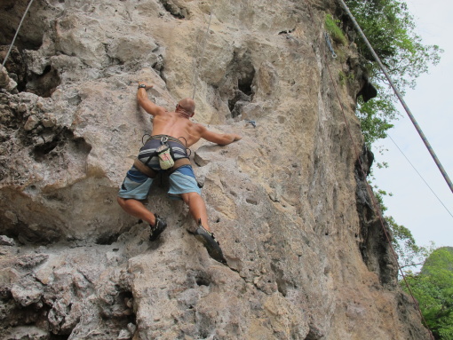 Rock climbing at Railay Beach, Krabi in Thailand.