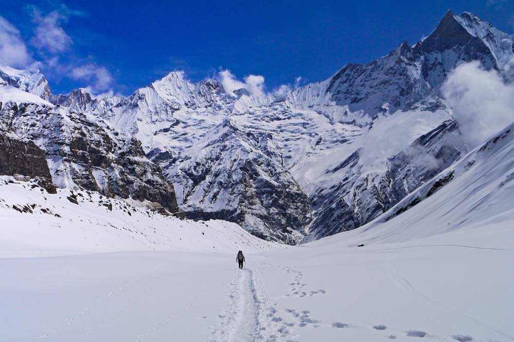 Campbell surrounded by snow-capped mountains on the way to Annapurna Base Camp