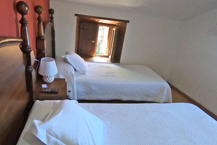 A small twin room with two single beds