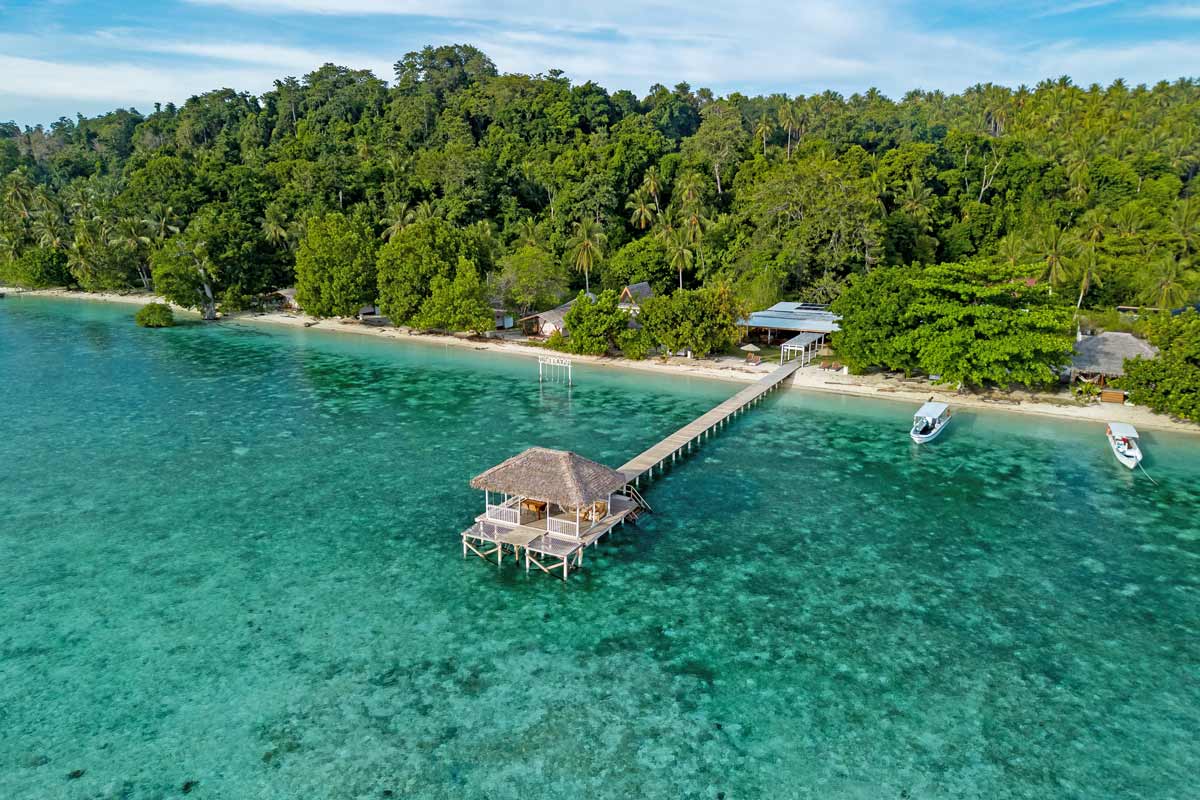 jetty for arriving boats on tropical island with beautiful coral reefs