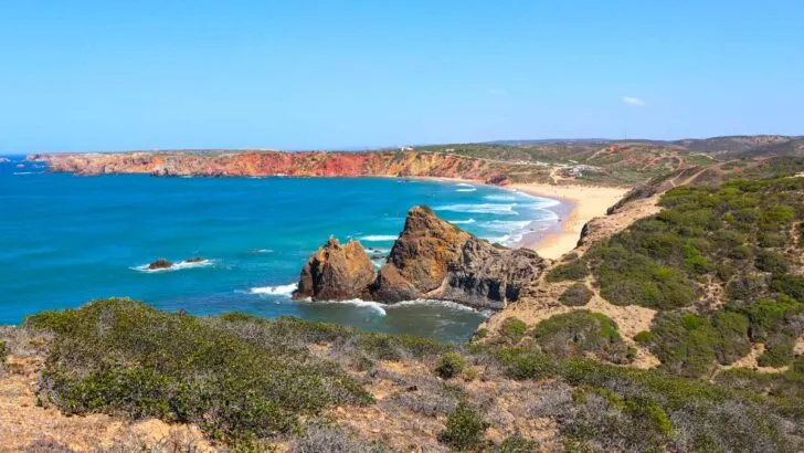 A view of a sandy beach from the top of the cliffs near Carrapateira, Portugal