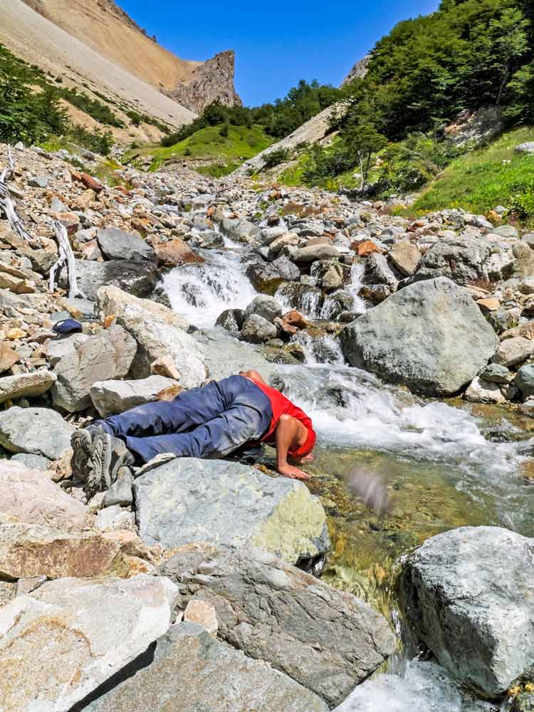 Campbell drinking water from the river on the Las Horquetas trek