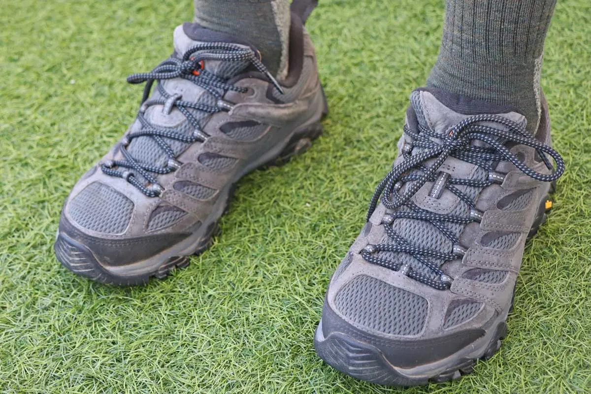 Man wearing Grey Merrel Hiking shoes on artificial grass