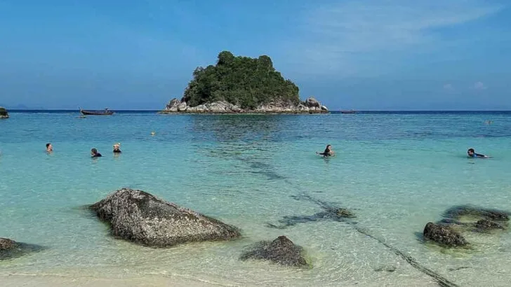 beach with crystal clear water and little island off shore