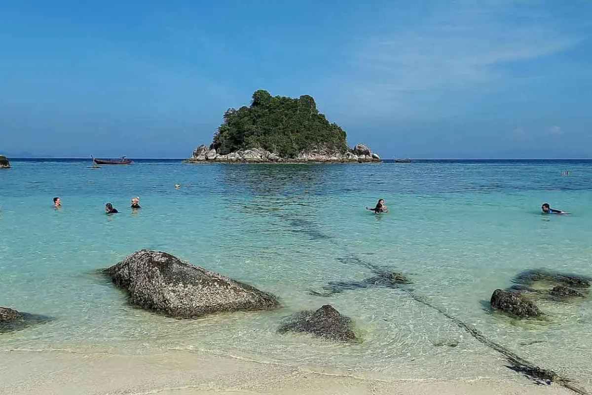 beach with crystal clear water and little island off shore