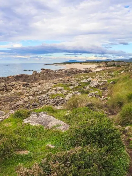 Stunning coastal scenery with a sandy beach surrounded by the rocks in Northern Portugal