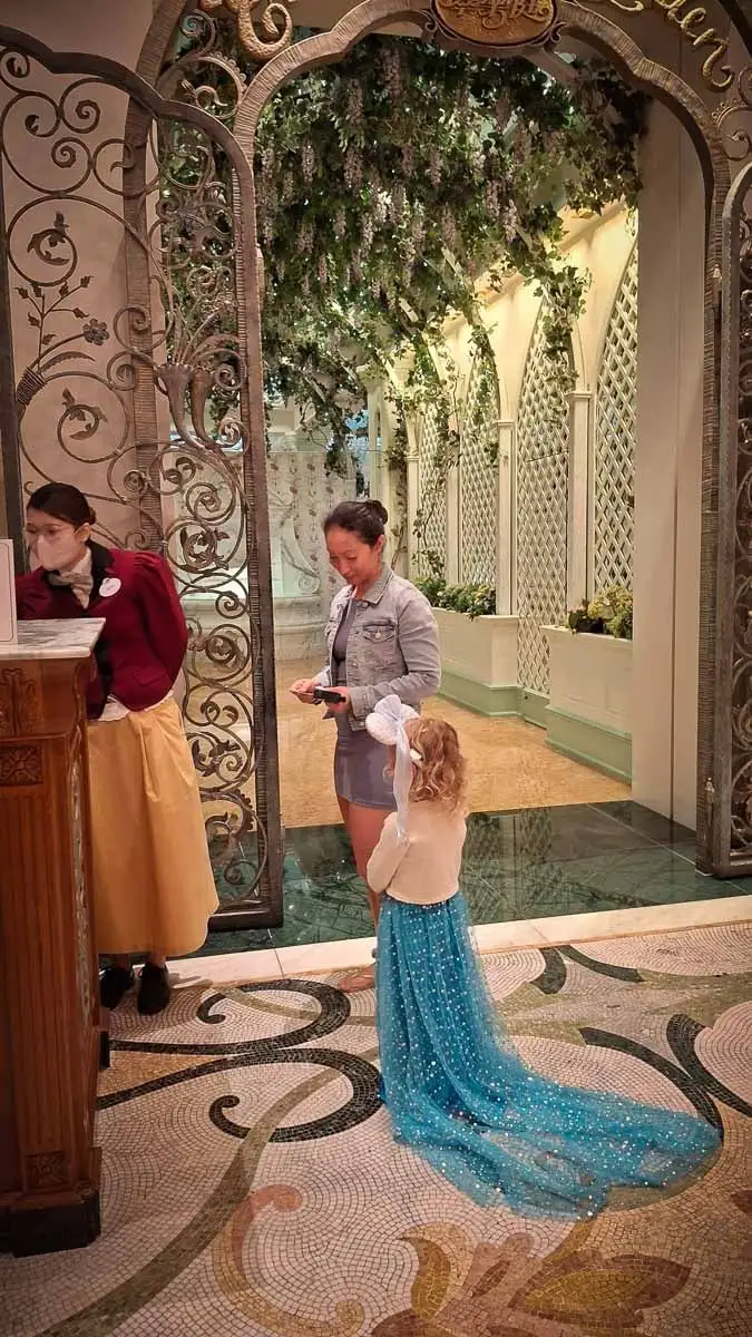 mother and daughter at large, fancy entrance to hotel