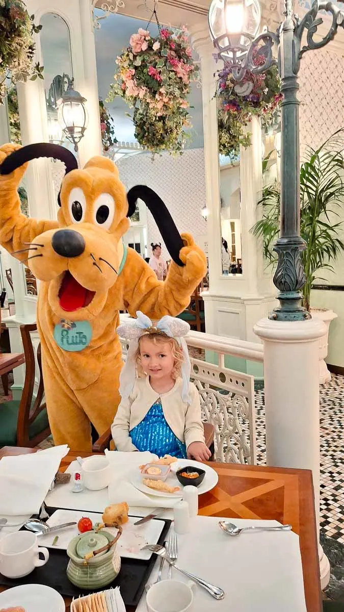 Pluto with little girl at breakfast
