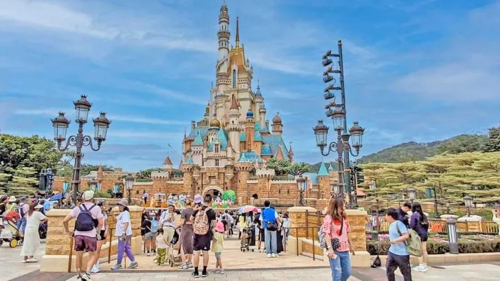 Disneyland castle surrounded by tropical setting