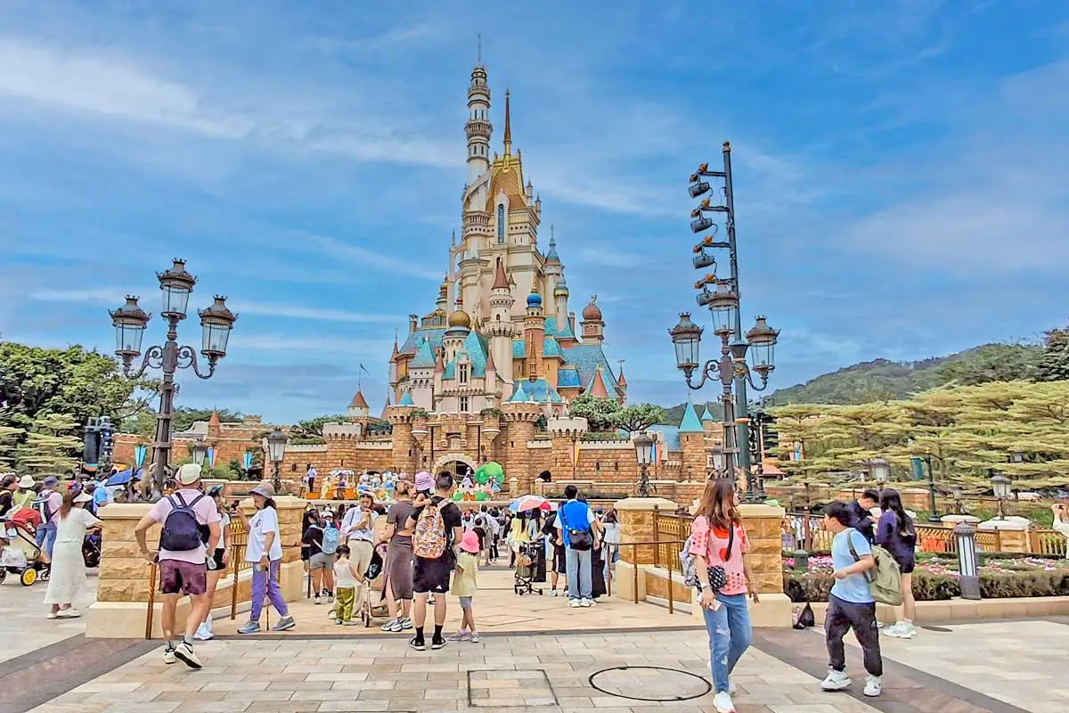 Disneyland castle surrounded by tropical setting