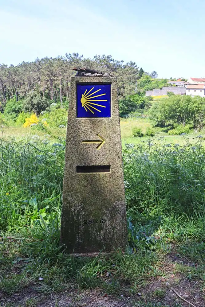 A traditional Camino sign in the fields in Galicia, Spain