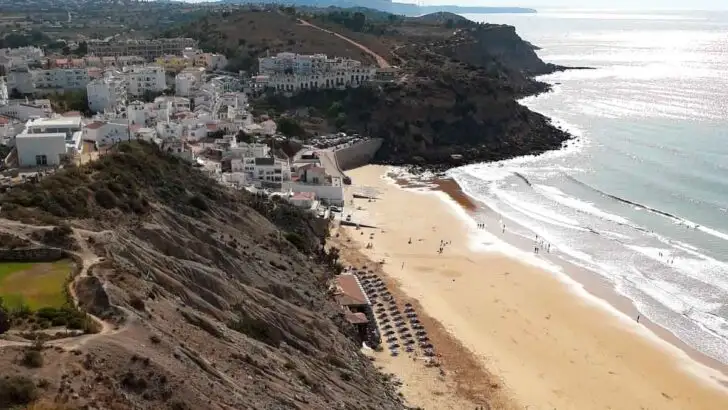 large beach with white washed houses in the background