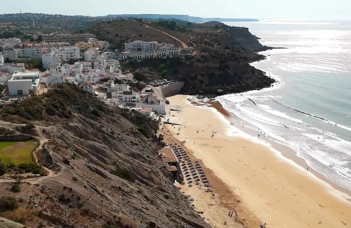 large beach with white washed houses in the background