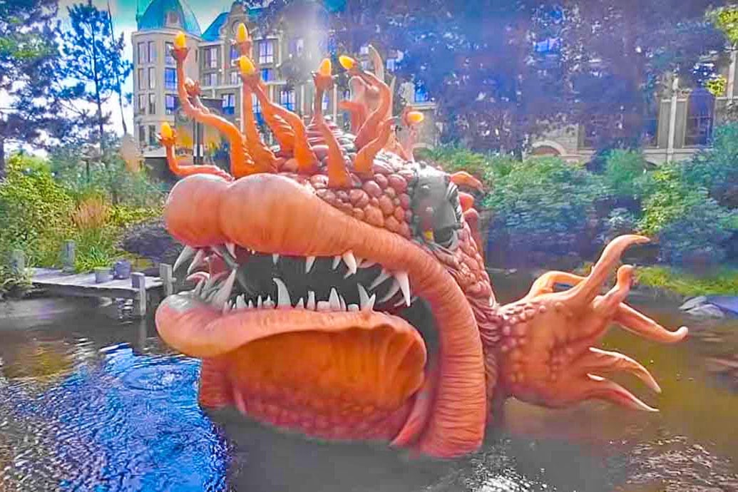 big orange fish with big teeth looking out of the water