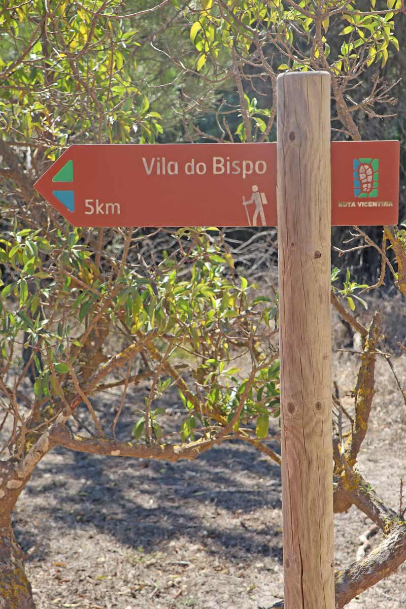 wooden sign indicating 5km to Vila do Bispo