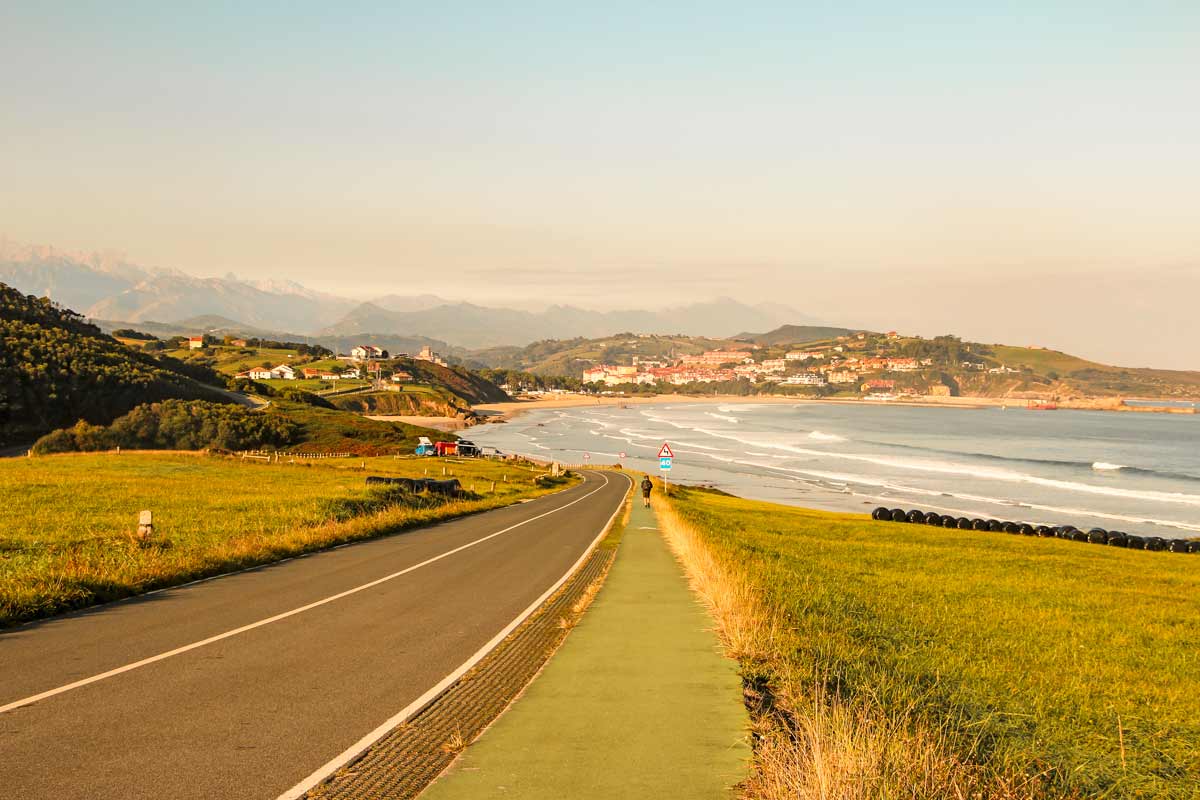A road and a walking trail winding along the coast on the Camino del Norte