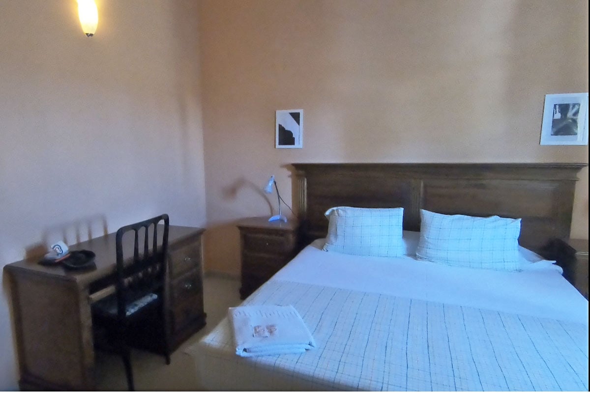 A double room with a wooden desk and chair in an albergue on the Camino Frances