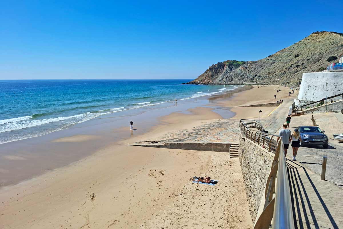 A sandy beach surrounded by the cliffs in Burgau, Algarve