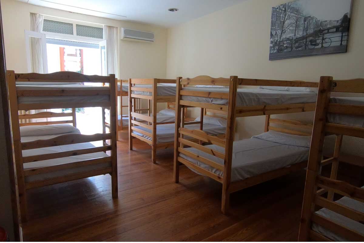 A dormitory room with 4 bunk beds in a private albergue on the Camino Frances