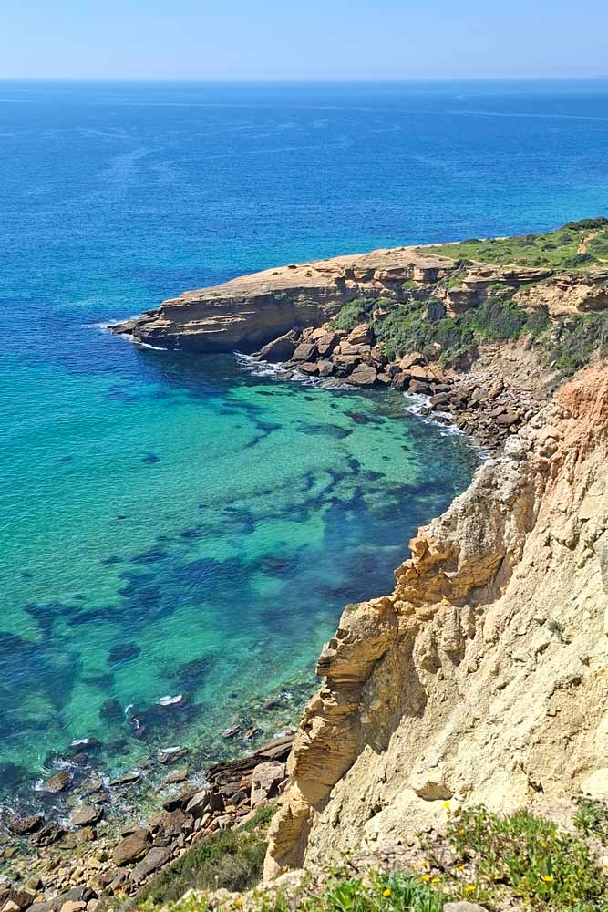 Rugged limestone cliffs and the turquoise color sea in the Algarve, Portugal