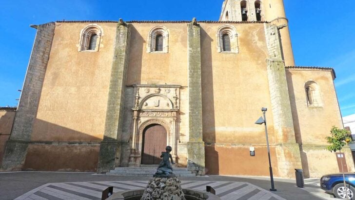 A Spanish church with a small fountain and the square in a small town in the south of Spain