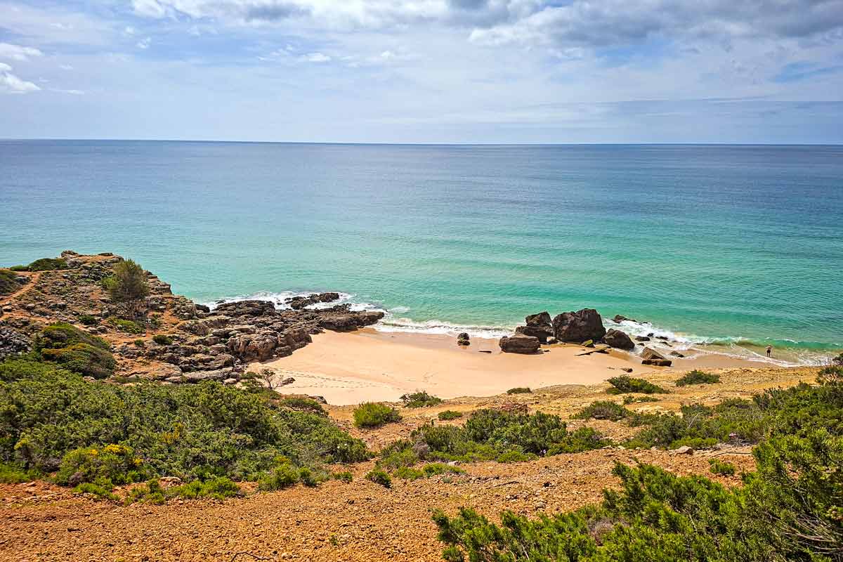 The turquoise color water and a sandy unspoiled beach, Algarve, Portugal