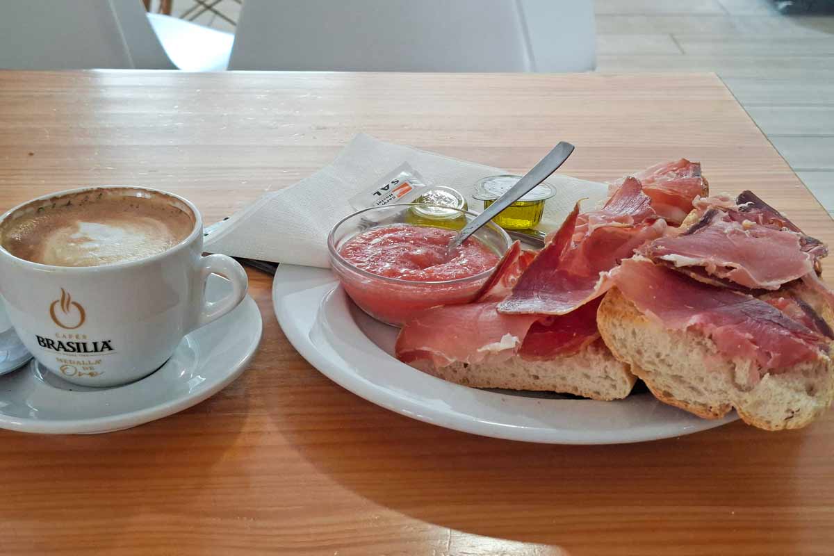 Toasted baguette with Spanish jamon, fresh tomato past and a cappuccino