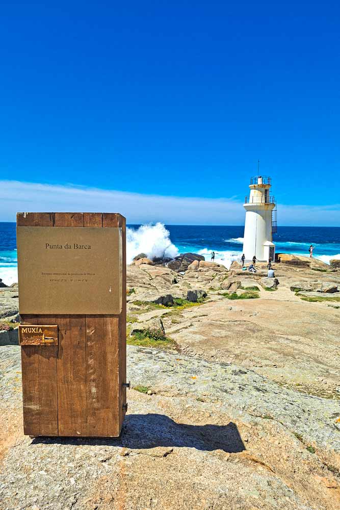 A small lighthouse on the edge of the rocky cliffs at Cape Muxia
