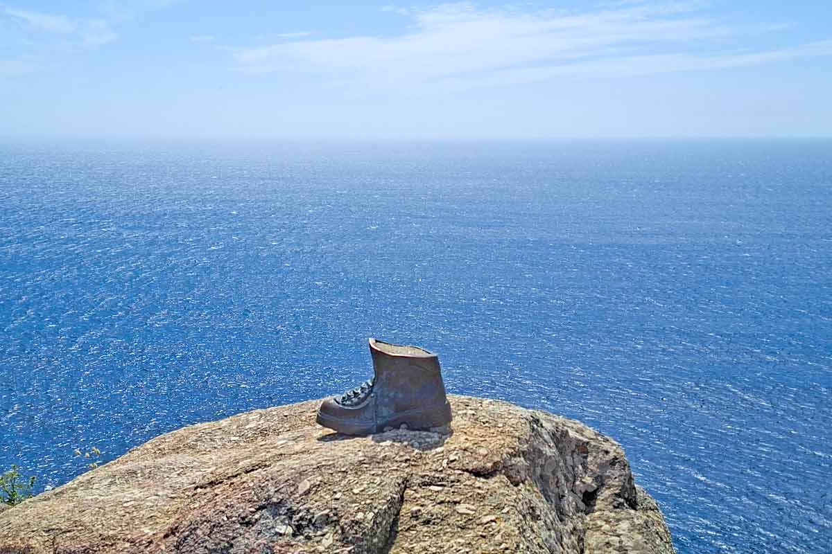 A metal shoe on a rock at the edge of the cliff at Cape Finisterre