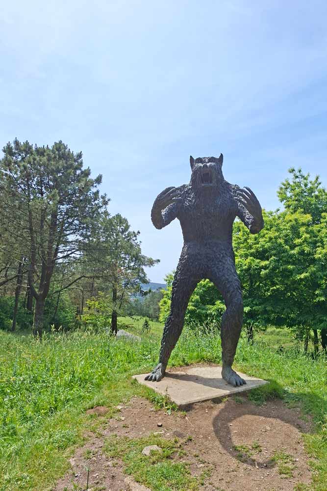 A big sculpture of Vakner (werewolf) in the forest on the Camino Finisterre