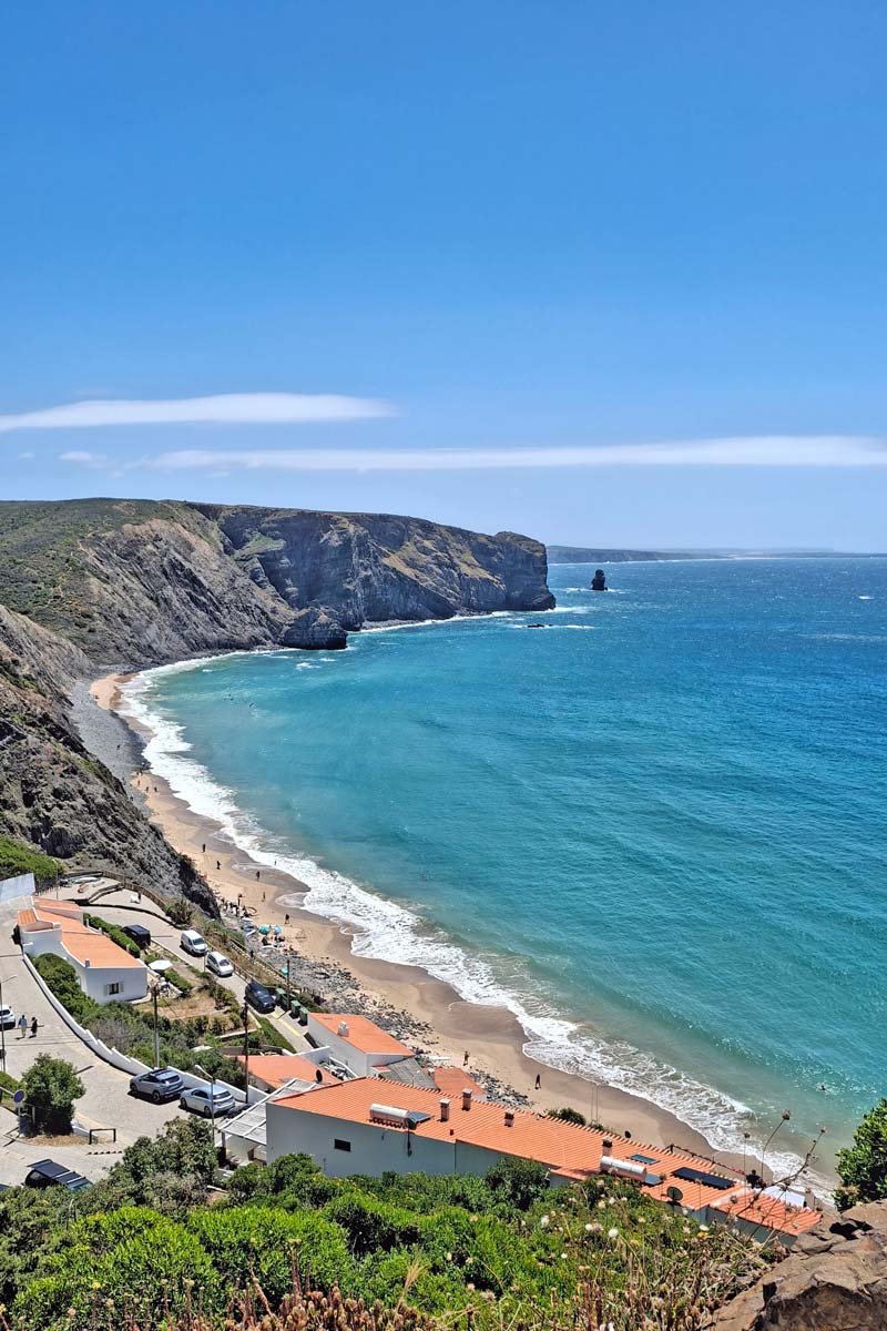 view of a long beach from cliffs above