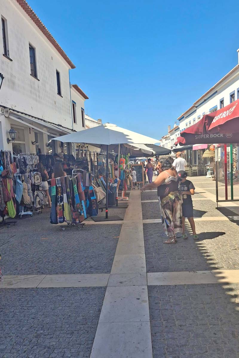 cobblestone walking street with umbrellas