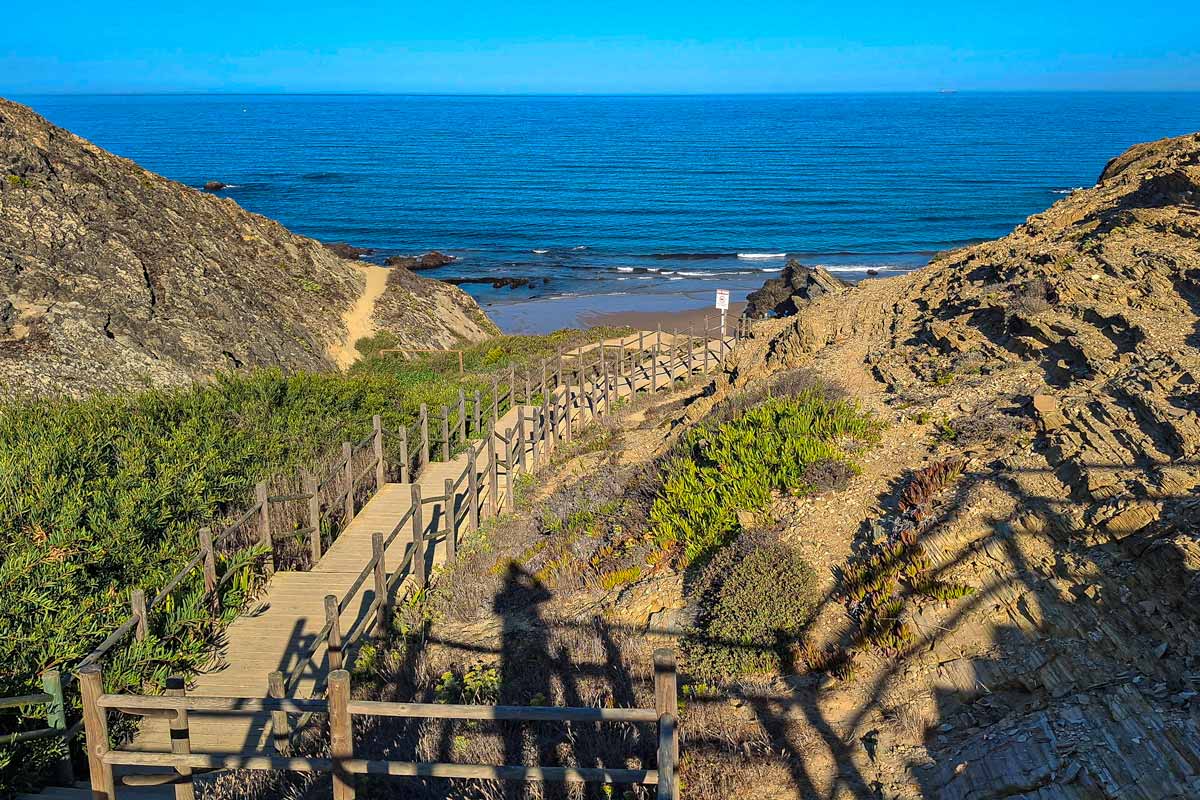 wooden stairs leading down the cliffs to the ocean