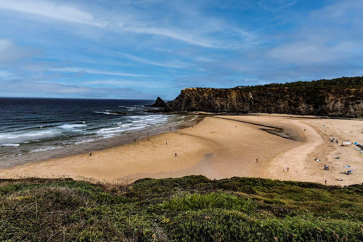 large sandy beach bordered by cliffs