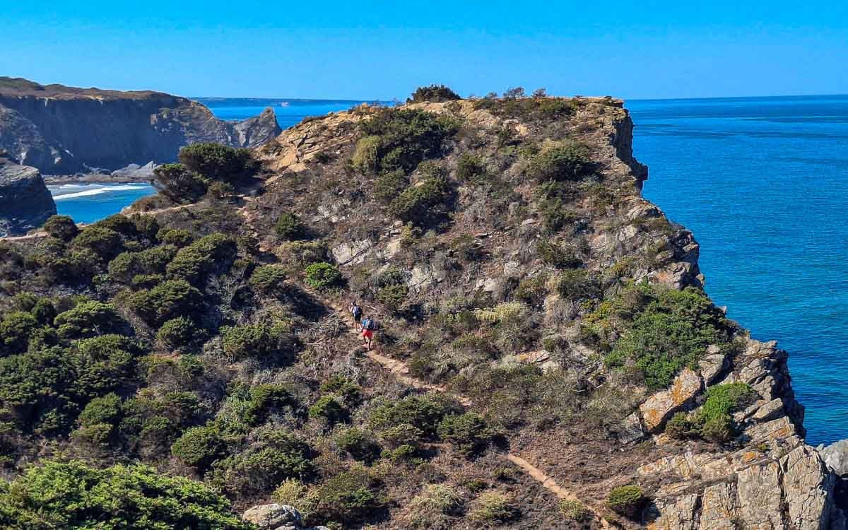 steep climb with 2 hikers overlooking the ocean