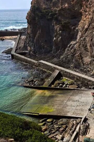 nice harbor below the cliffs with small boats