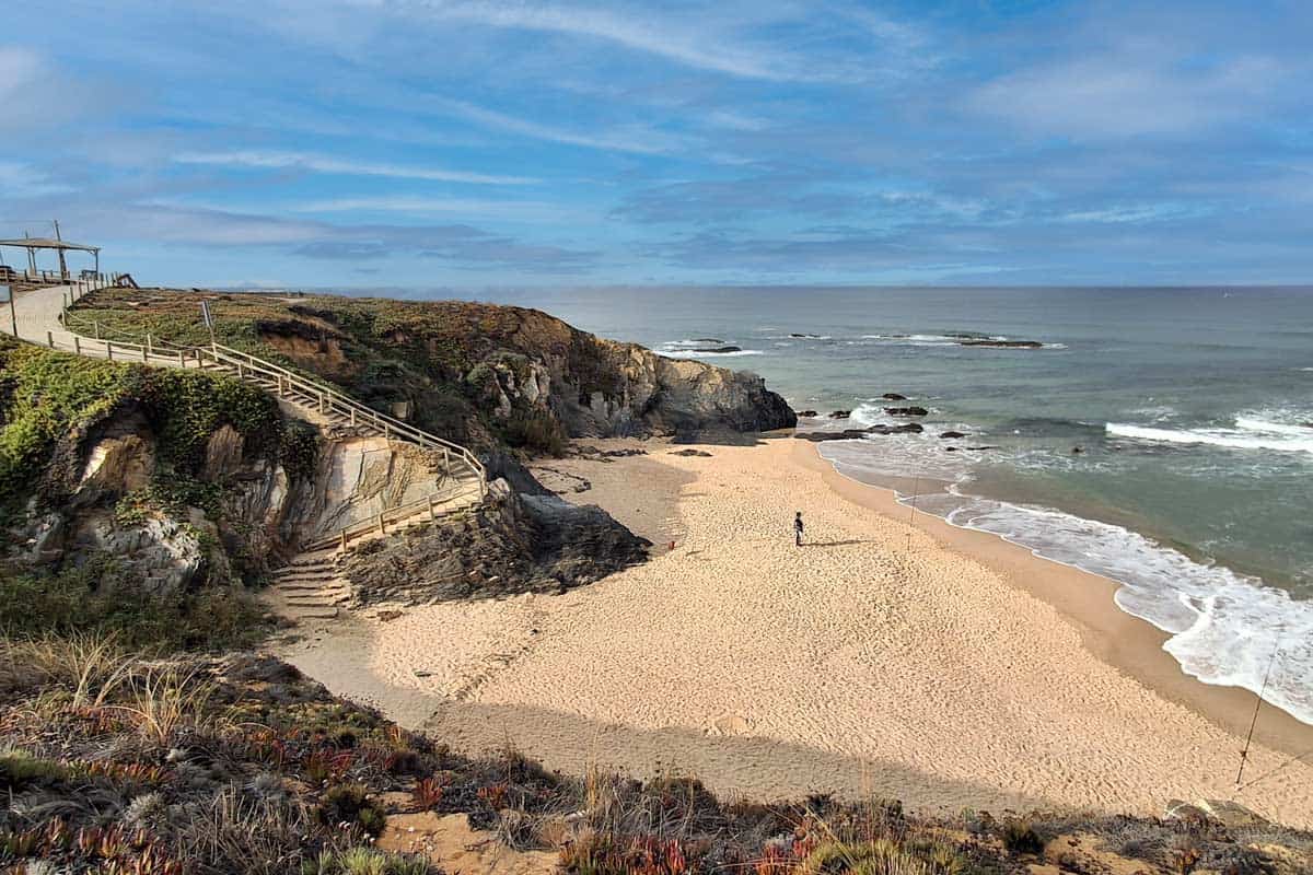 beautiful beach with stairs going up the hill