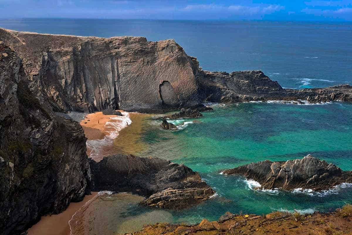 cliffs dropping into the ocean with small beaches at the bottom